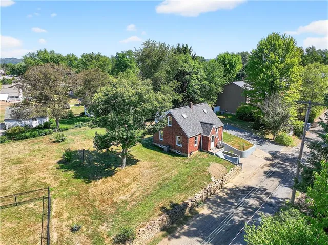 an aerial view of a house with a yard basket ball court and outdoor seating