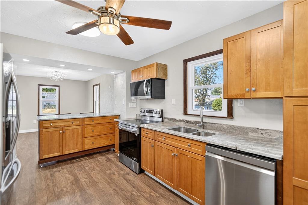 1320 Eckert Road Monaca, PA 15061 - Photo 6 of 30 a kitchen with stainless steel appliances granite countertop a sink a stove and a refrigerator