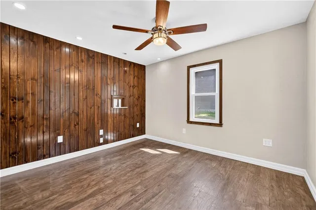 a view of an empty room with wooden floor
