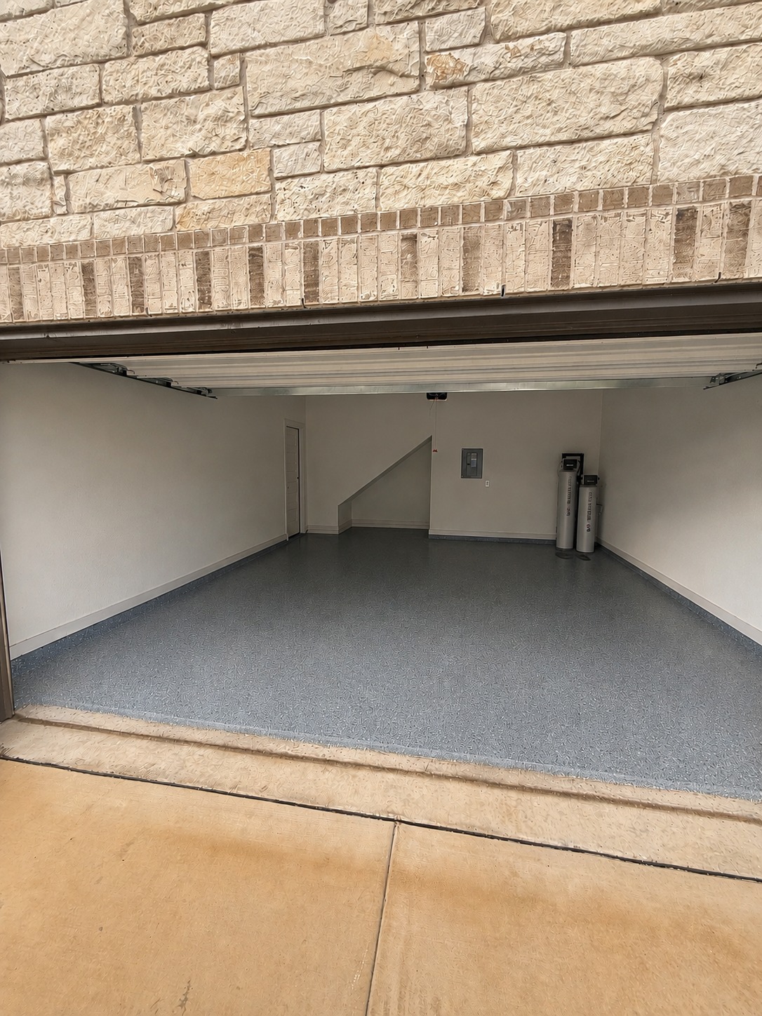 1213 Bryson Rdg Trail Leander, TX 78641 - Photo 14 of 16 A pristine garage interior featuring a durable, speckled flooring finish.