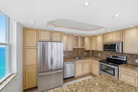 a kitchen with a sink stove and refrigerator