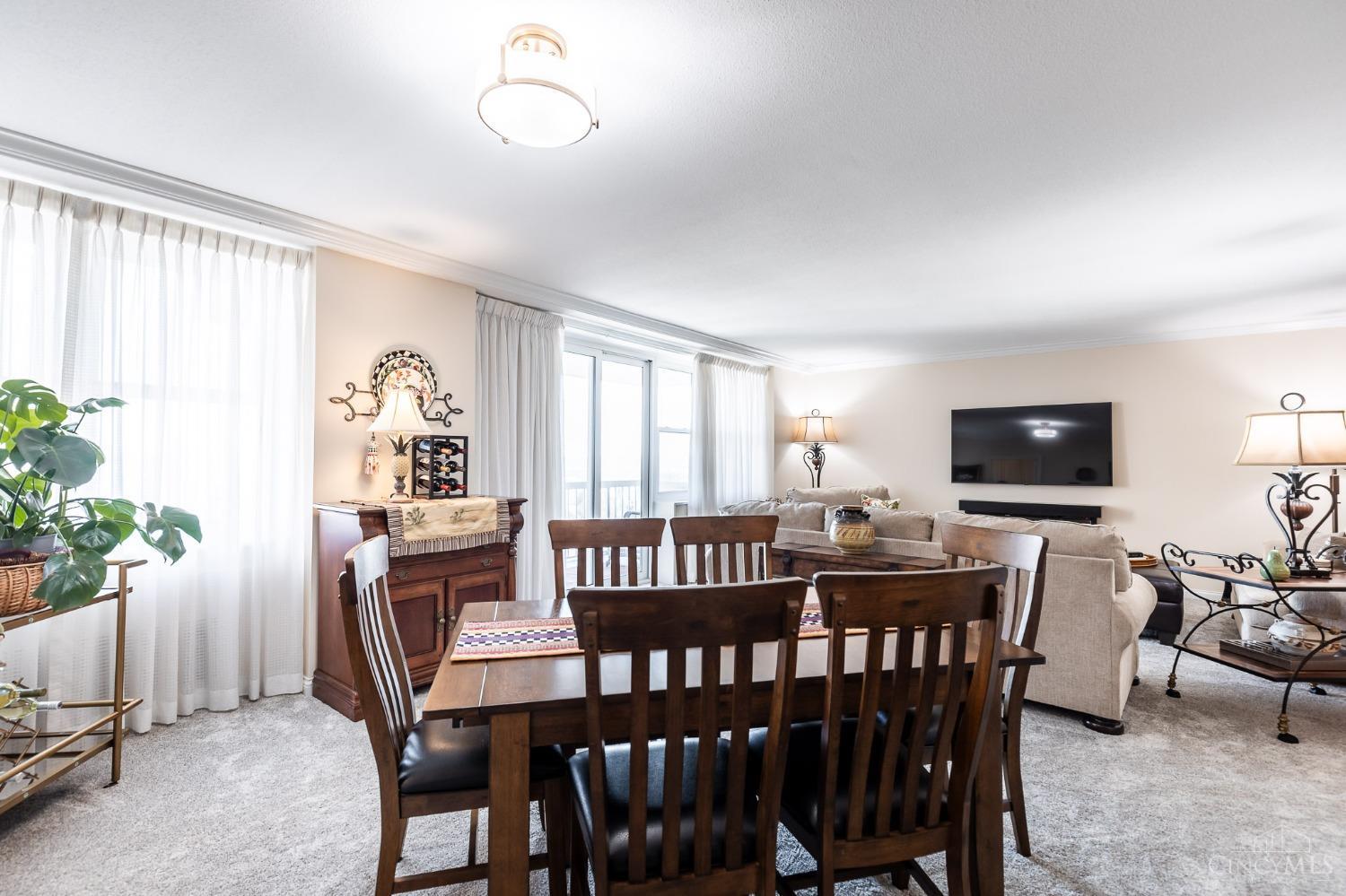 2444 Madison Road, Unit 901 Cincinnati, OH 45208 - Photo 7 of 44 The spacious dining area features updated lighting and wall-to-wall carpet. The dining area is open to the living room and adjoins the kitchen.