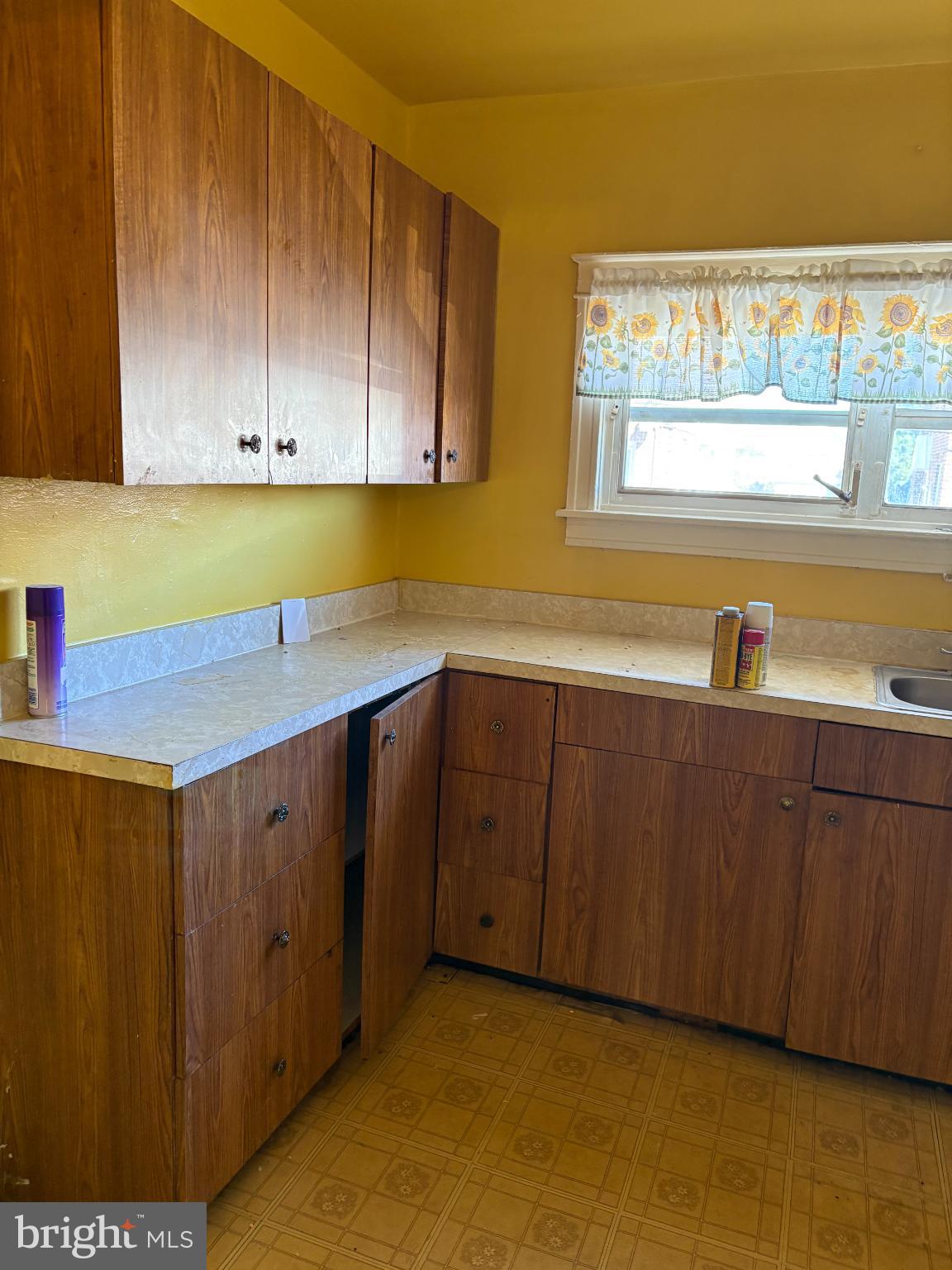 7837 Provident Street Philadelphia, PA 19150 - Photo 8 of 26 a kitchen with a sink cabinets and a window