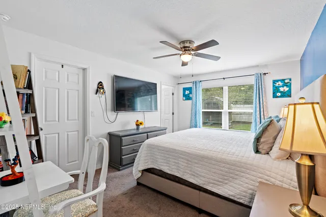 a bedroom with bed and a window