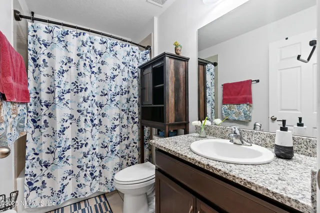 a bedroom with a bed next to a window