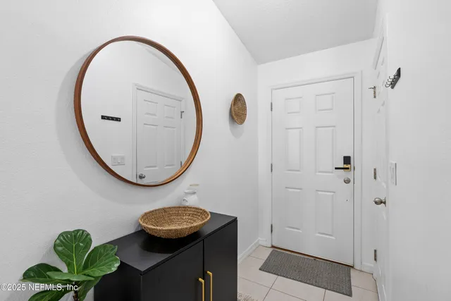a bathroom with a granite countertop sink a toilet a shower and a mirror