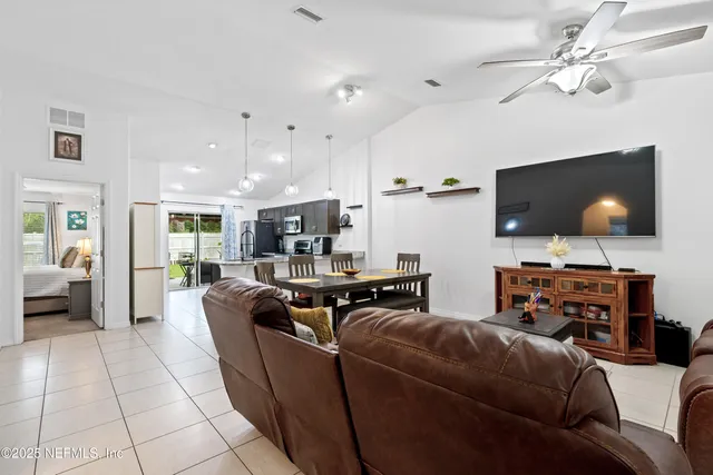 a kitchen with stainless steel appliances granite countertop a stove top oven a sink dishwasher a refrigerator and a refrigerator