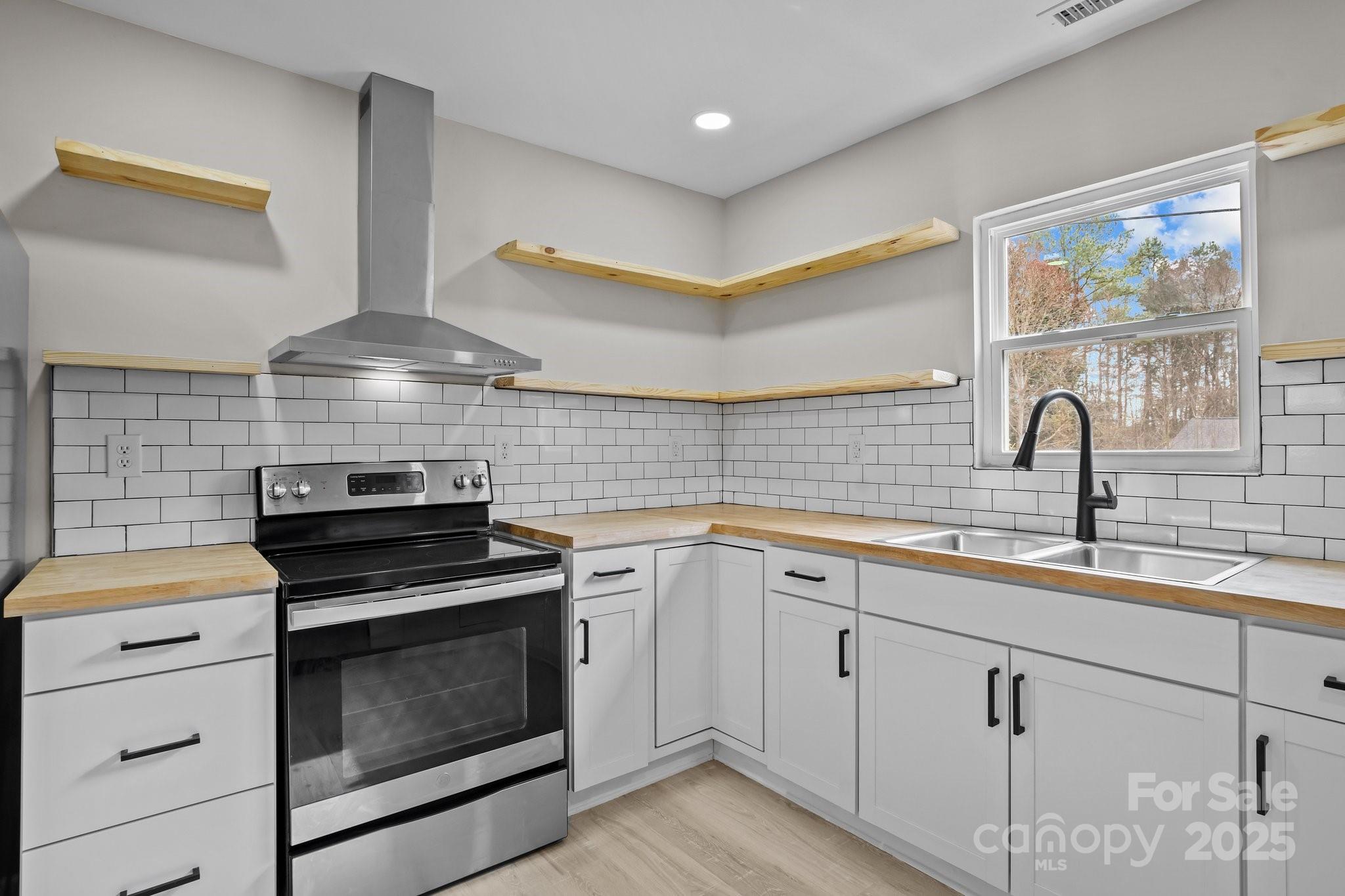 937 Gladstone Road Mocksville, NC 27028 - Photo 17 of 34 a kitchen with a sink stove and cabinets