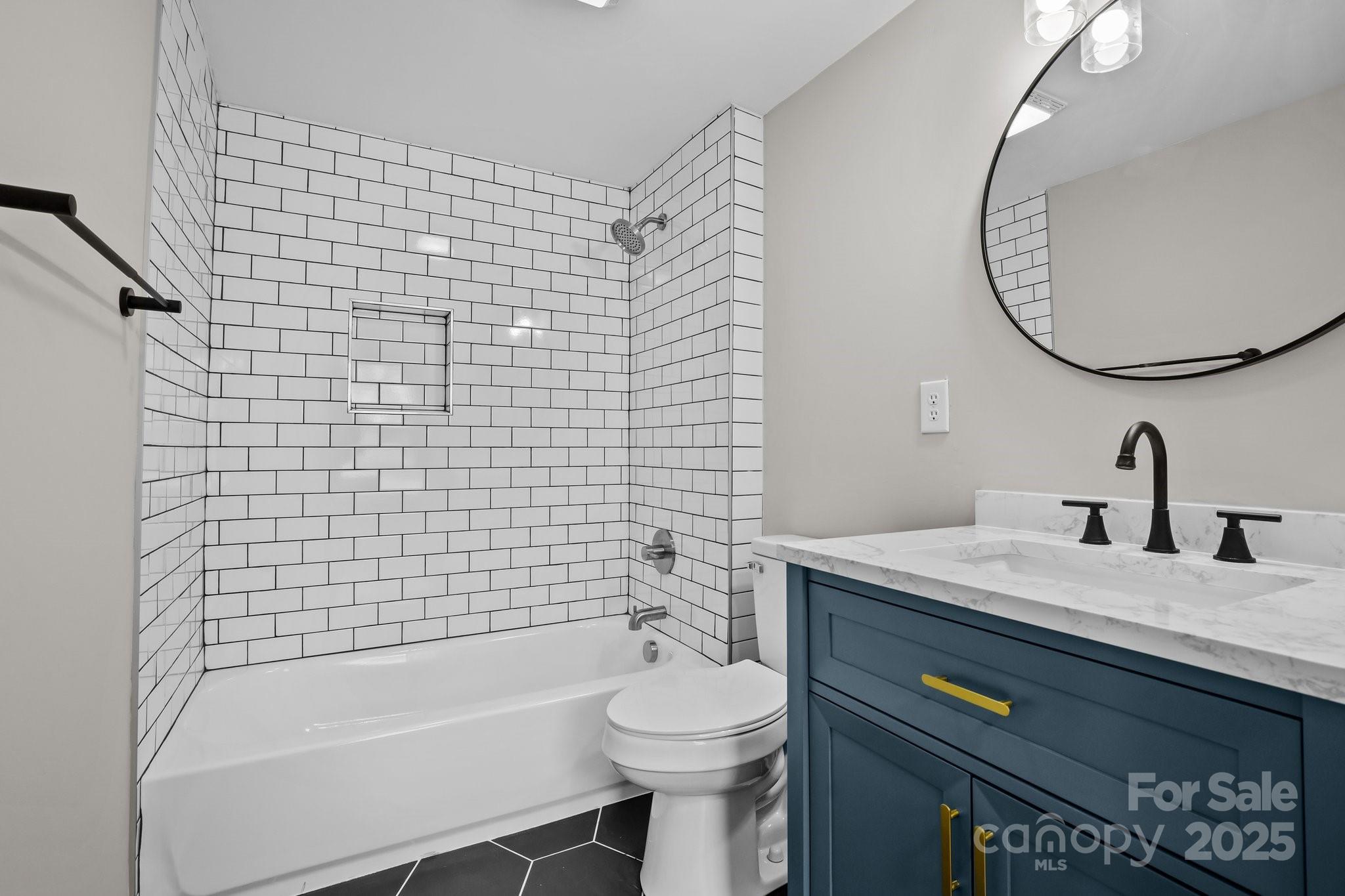 937 Gladstone Road Mocksville, NC 27028 - Photo 19 of 34 a bathroom with a sink a toilet and a mirror