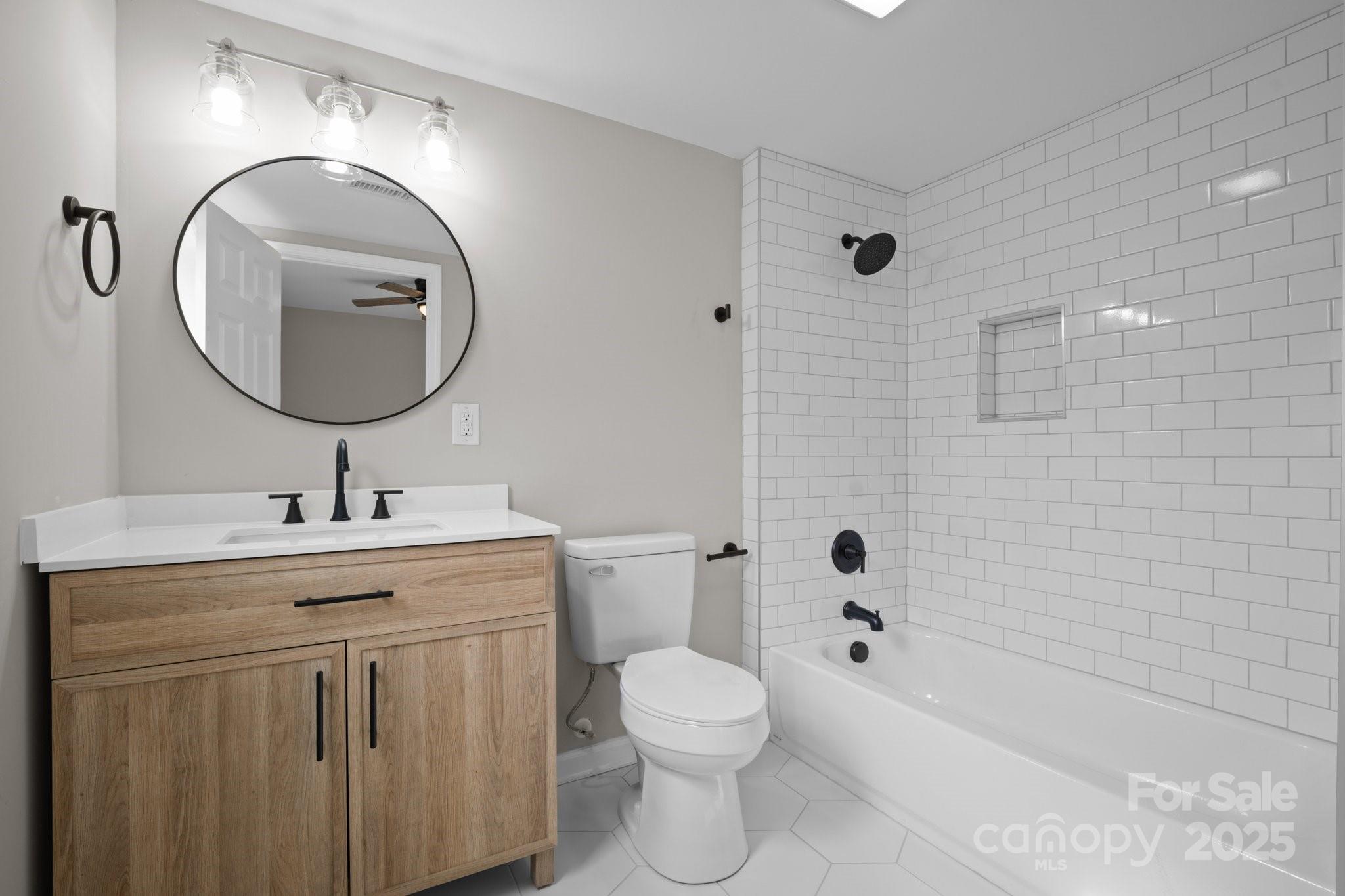 937 Gladstone Road Mocksville, NC 27028 - Photo 23 of 34 a bathroom with a toilet sink and mirror