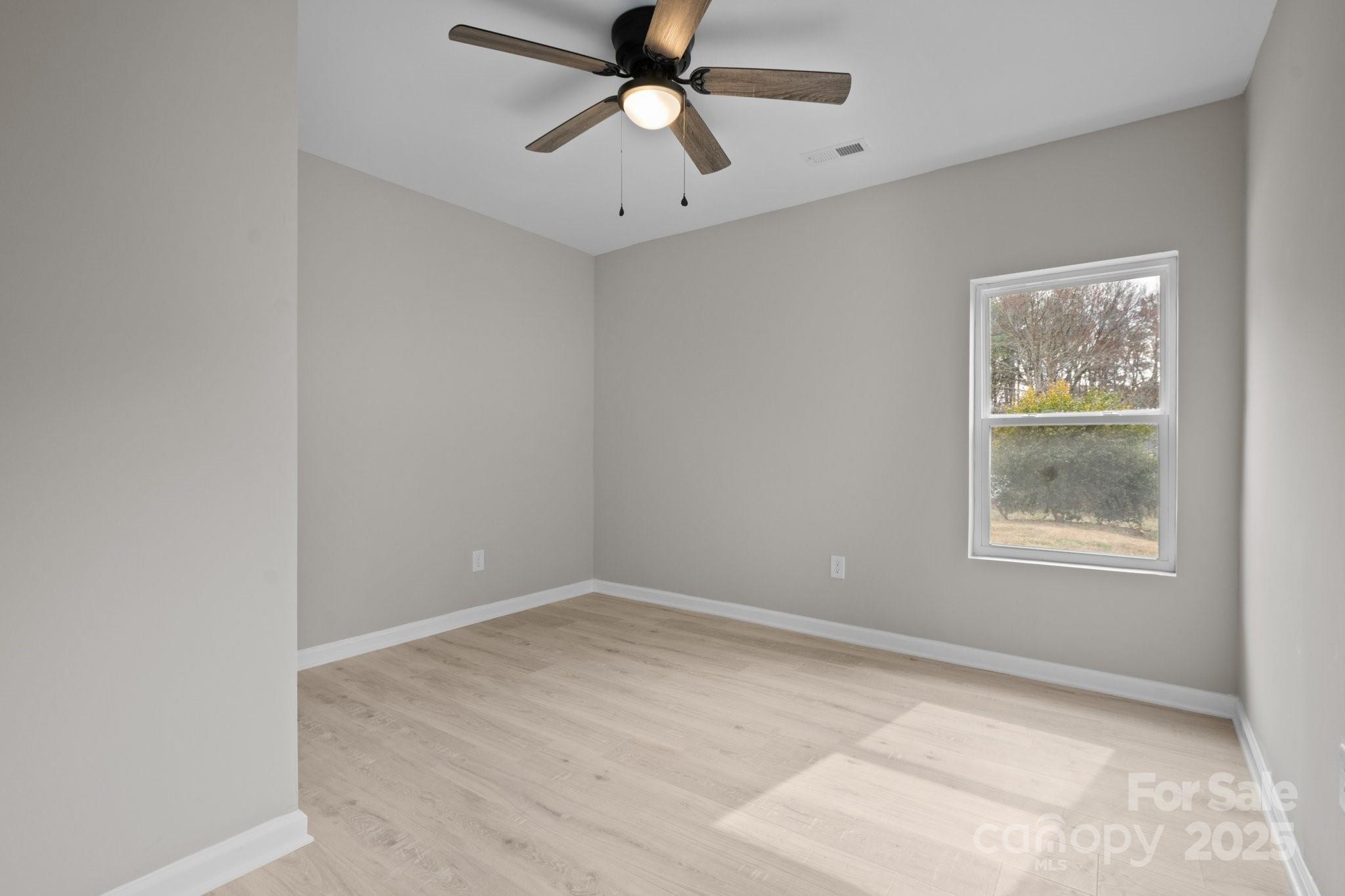 937 Gladstone Road Mocksville, NC 27028 - Photo 28 of 34 an empty room with a window and a fan