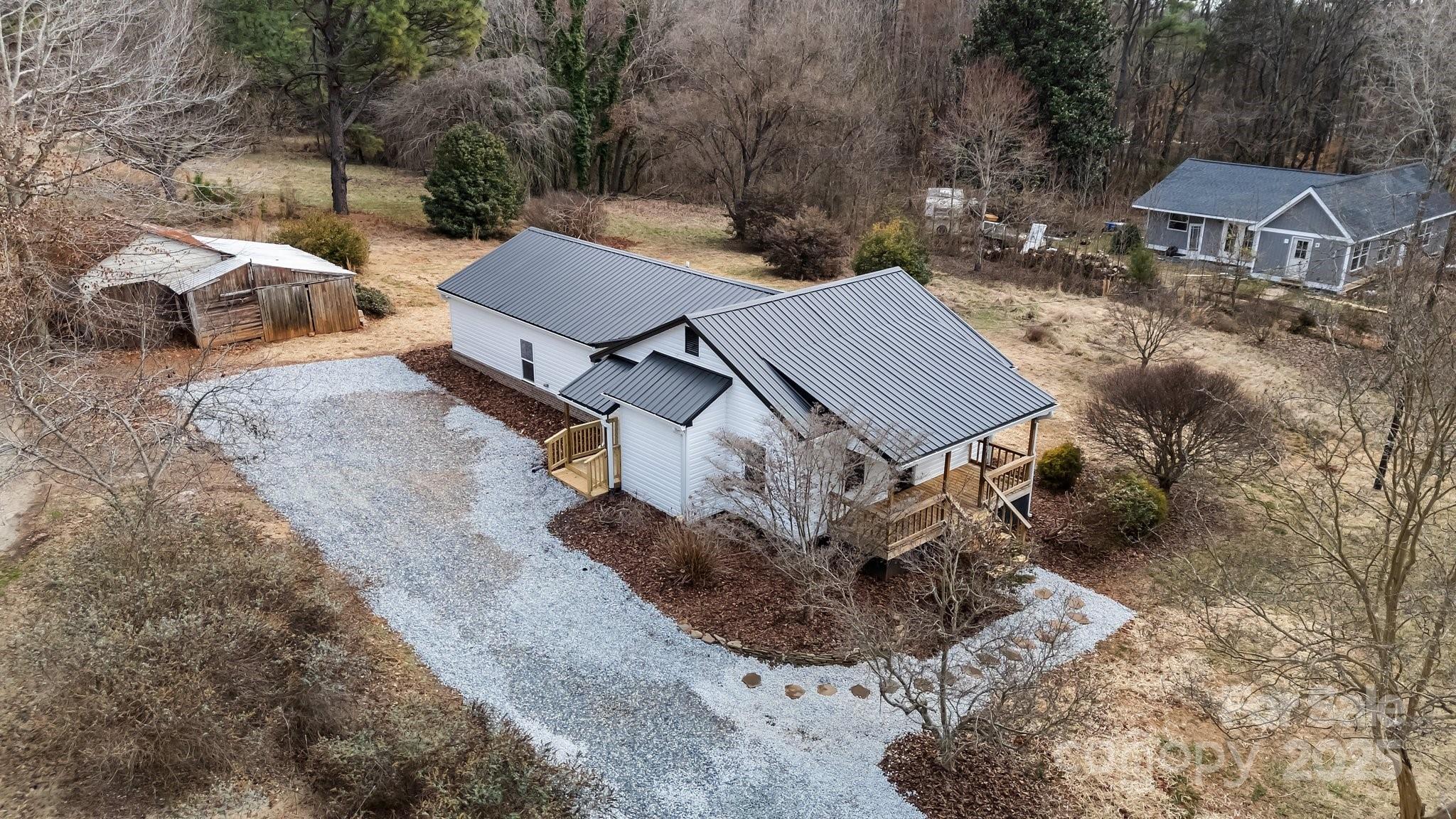 937 Gladstone Road Mocksville, NC 27028 - Photo 3 of 34 an aerial view of a house with a yard and parking