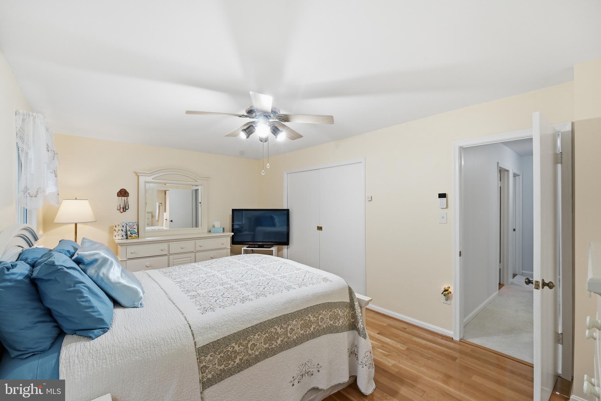 2304 Hidden Valley Lane Silver Spring, MD 20904 - Photo 32 of 54 a spacious bedroom with a bed and a chandelier