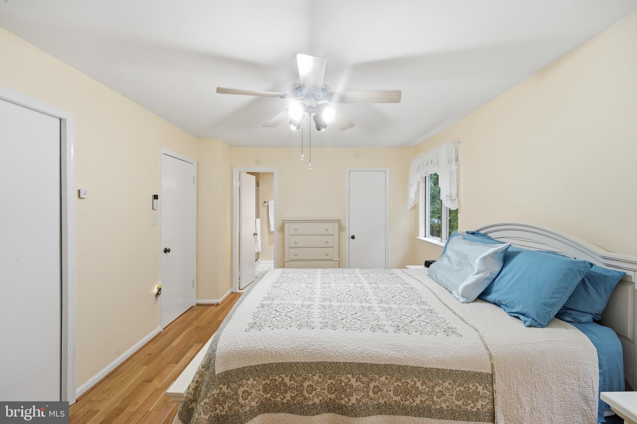 2304 Hidden Valley Lane Silver Spring, MD 20904 - Photo 33 of 54 a bedroom with a large bed and a chandelier fan