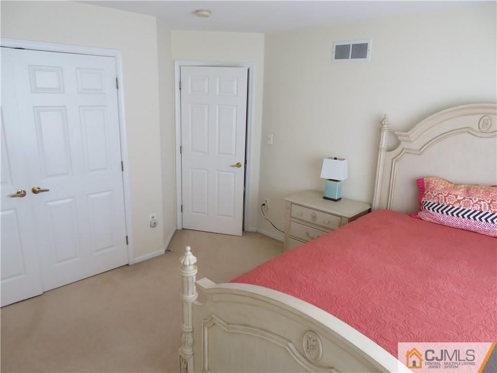 125 Castleton Road Princeton, NJ 08540 - Photo 15 of 24 a bedroom with a bed and a potted plant