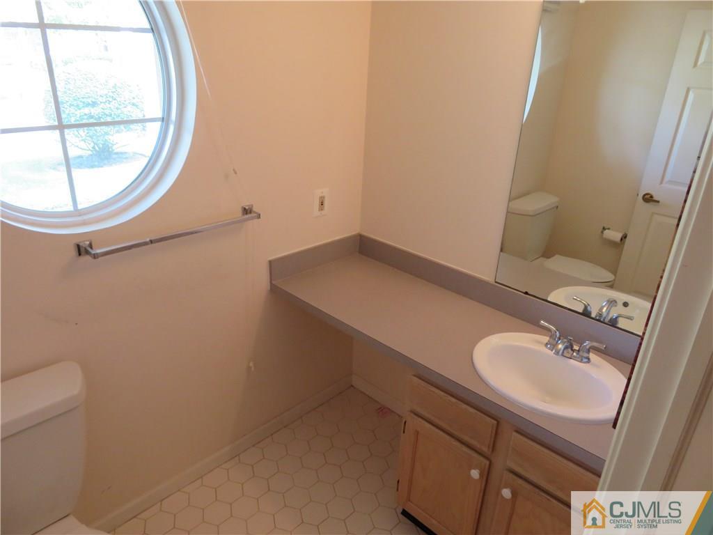 125 Castleton Road Princeton, NJ 08540 - Photo 3 of 24 a bathroom with a sink and a mirror