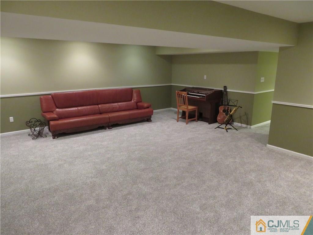 125 Castleton Road Princeton, NJ 08540 - Photo 21 of 24 a living room with furniture and a gym cycle