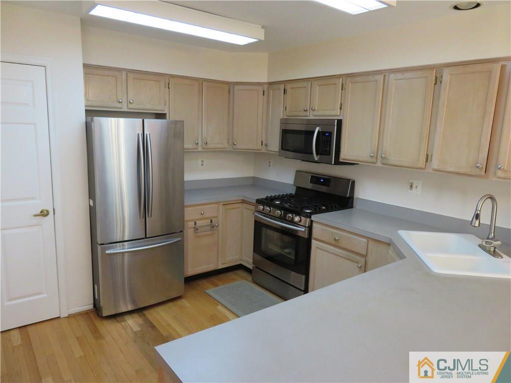 125 Castleton Road Princeton, NJ 08540 - Photo 5 of 24 a kitchen with granite countertop a refrigerator stove and microwave