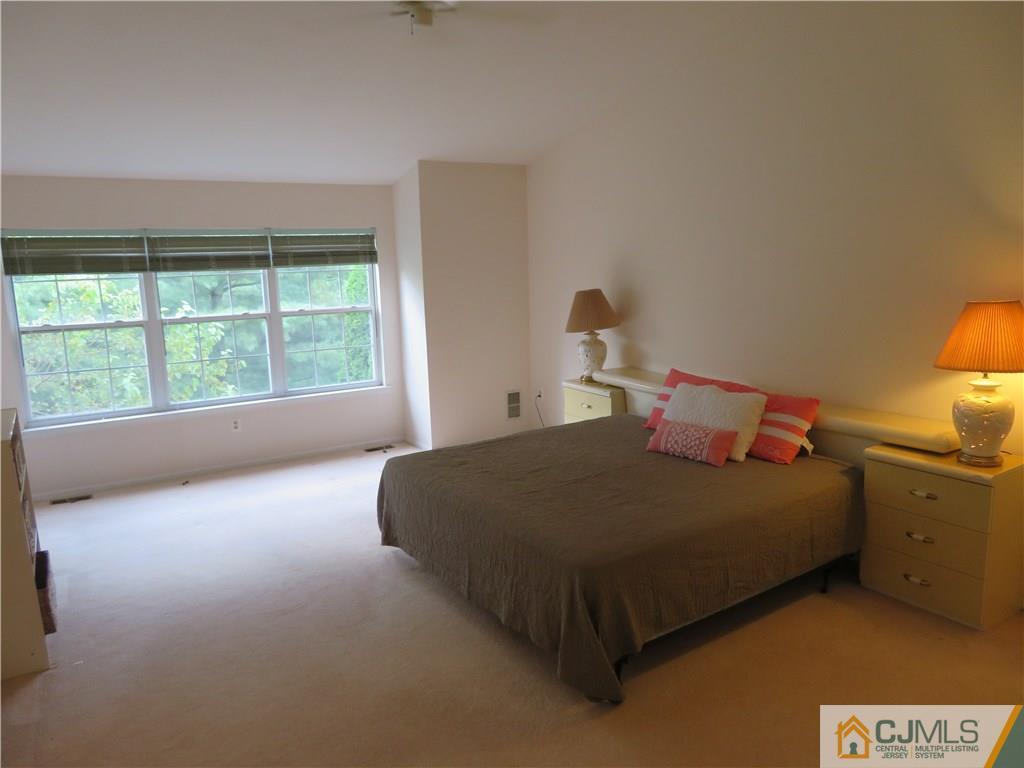 125 Castleton Road Princeton, NJ 08540 - Photo 9 of 24 a bed sitting in a bedroom next to a window
