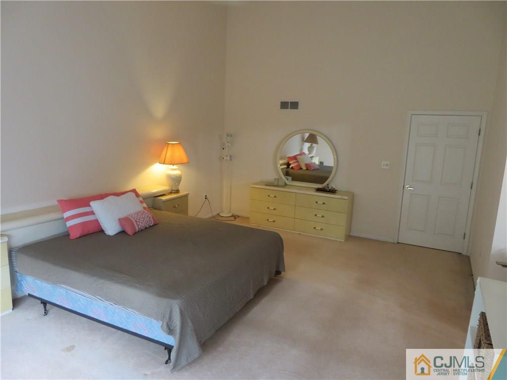 125 Castleton Road Princeton, NJ 08540 - Photo 10 of 24 a bedroom with a bed and a lamp on table