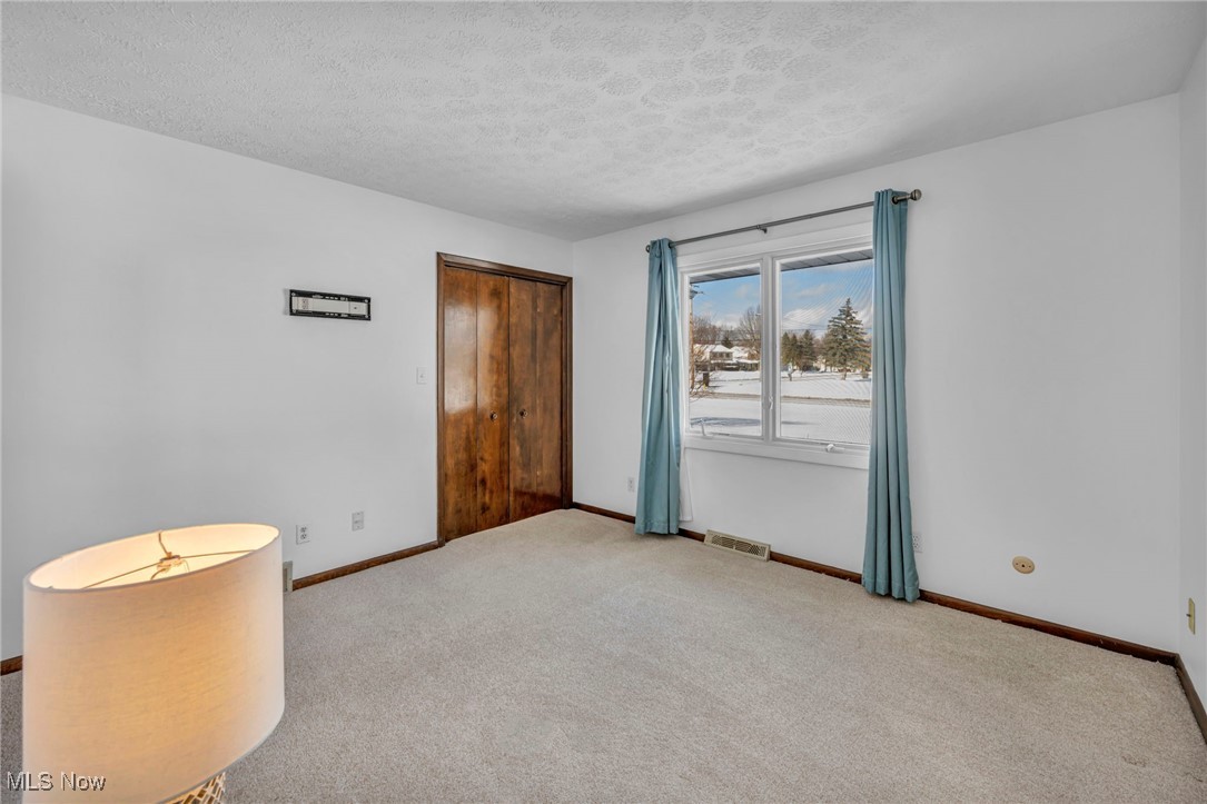 36350 Bainbridge Road Solon, OH 44139 - Photo 14 of 38 Bedroom room with a textured ceiling and light colored carpet