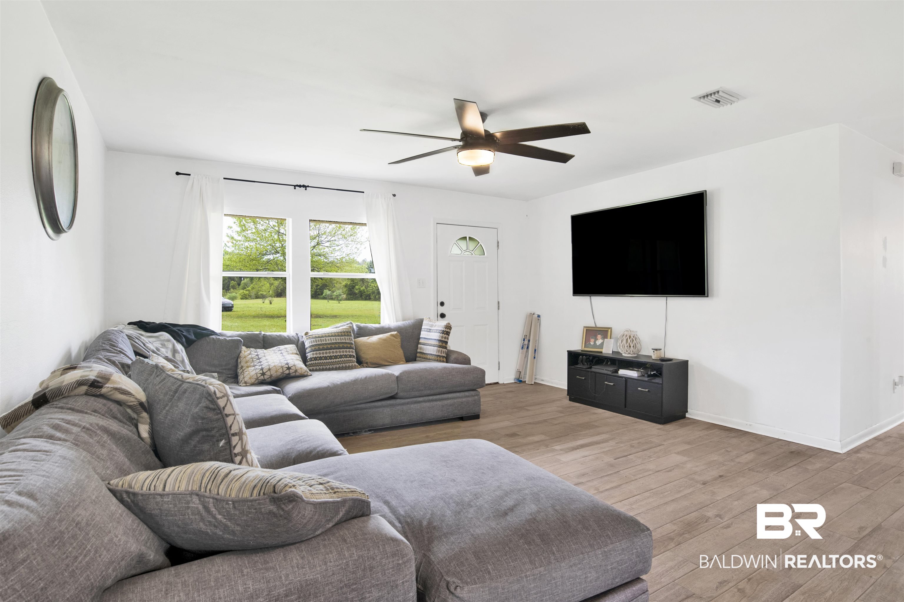 10244 Magnolia Road Irvington, AL 36544 - Photo 4 of 37 Living room with baseboards, visible vents, ceiling fan, and wood finished floors