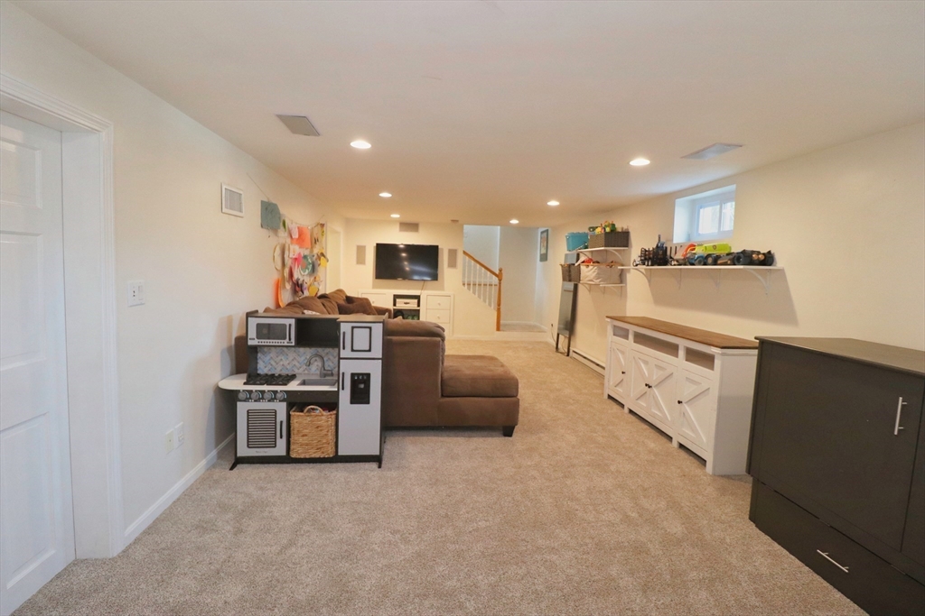 341 Reedsdale Road Milton, MA 02186 - Photo 25 of 28 a living room with stainless steel appliances furniture and a view of kitchen