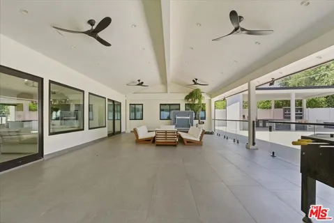 a living room with furniture and a floor to ceiling window