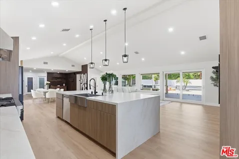 a kitchen with stainless steel appliances granite countertop a stove and cabinets
