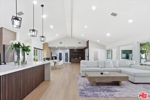 a large living room with furniture and a chandelier