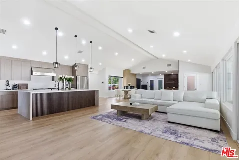 a living room with furniture and kitchen view