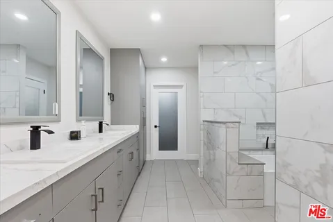 a bathroom with a double vanity sink and mirror