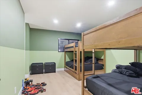 a bedroom with a bed and large mirror