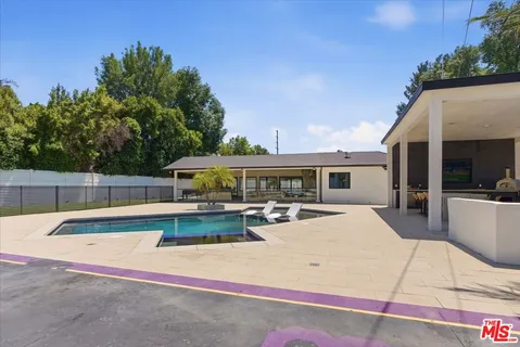a view of a house with pool porch and sitting area
