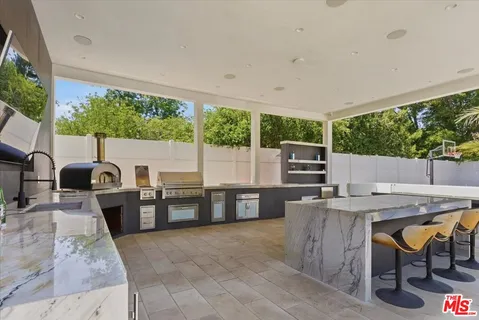 a kitchen with a table chairs and a stove