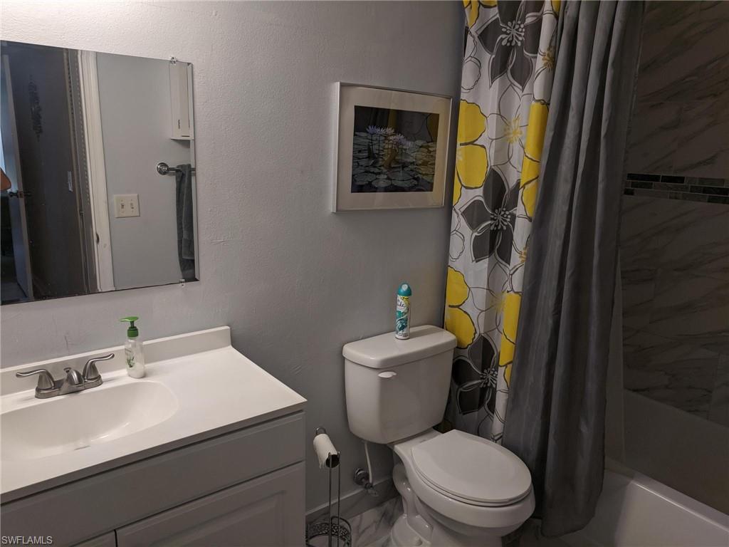13521 Eagle Ridge Drive, Unit 121 Fort Myers, FL 33912 - Photo 5 of 12 a bathroom with a sink toilet and shower