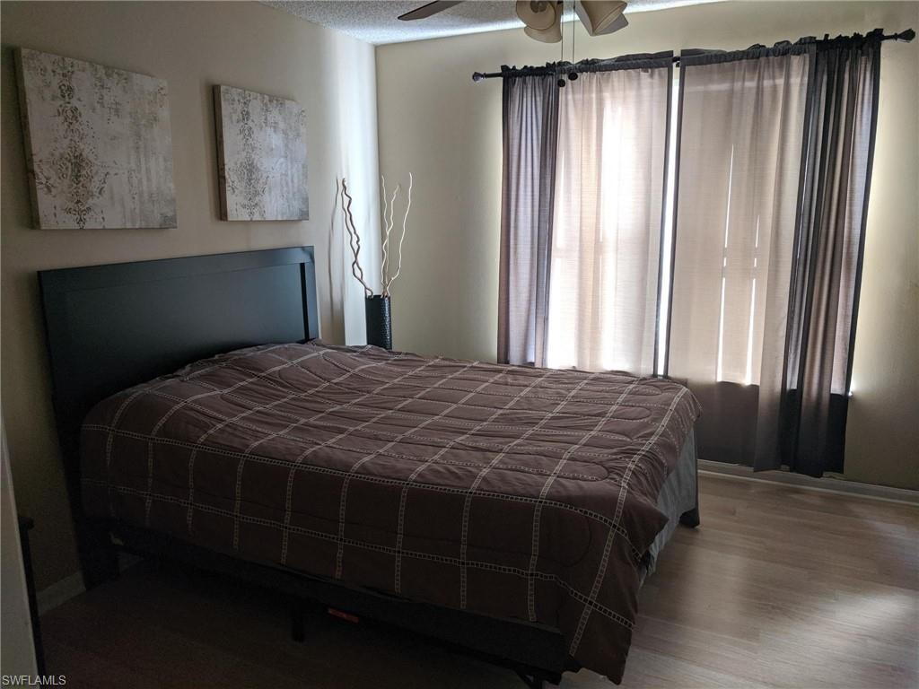 13521 Eagle Ridge Drive, Unit 121 Fort Myers, FL 33912 - Photo 6 of 12 a bedroom with a bed and a window