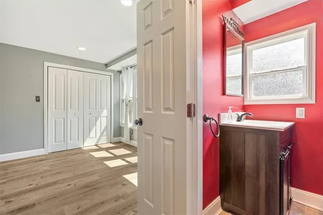 a view of a hallway with wooden floor and windows