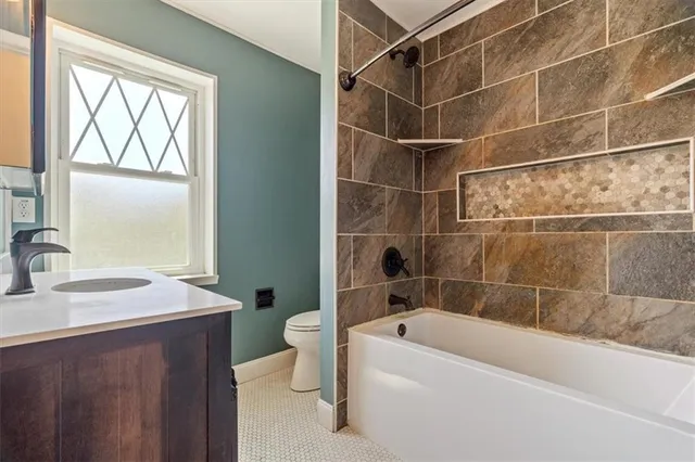 a bathroom with a sink mirror toilet and bathtub