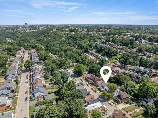 an aerial view of a house with a yard