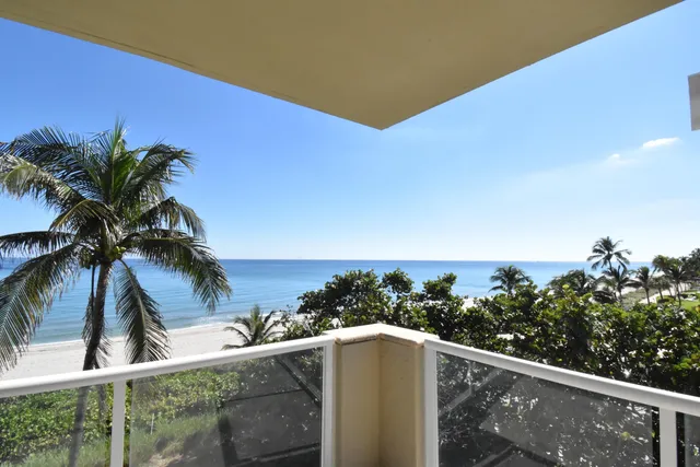 a view of a balcony with potted plants