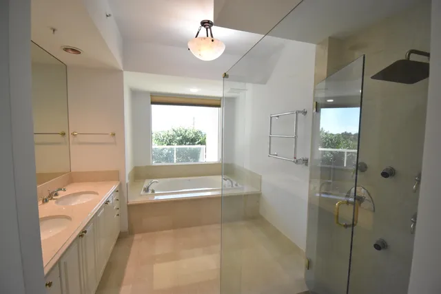 a white bath tub sitting in a bathroom next to a window