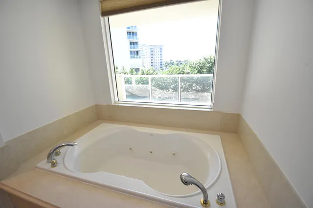 a bathroom with a shower sink and mirror