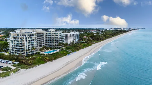 a living room with furniture a flat screen tv and kitchen view