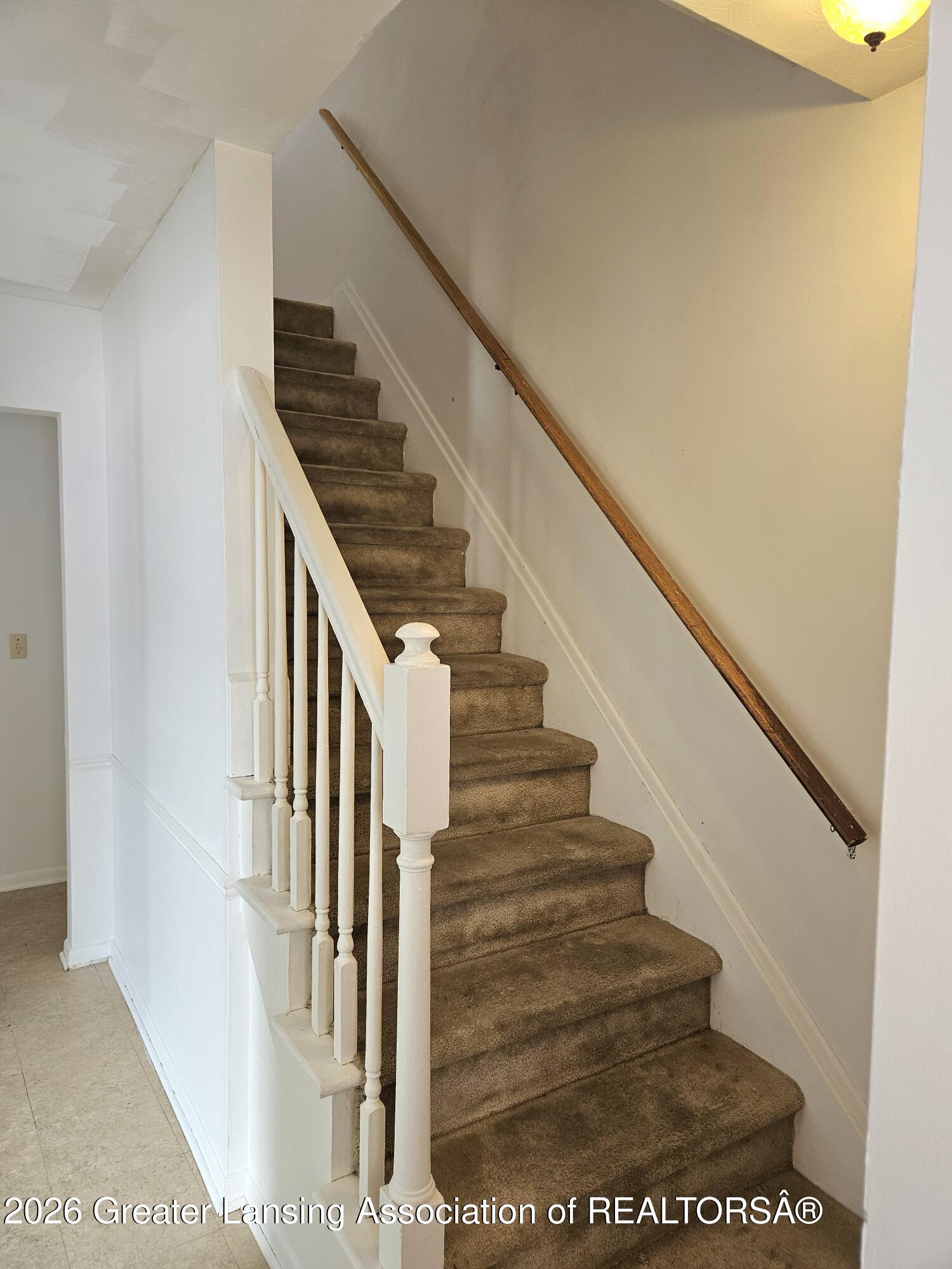 2800 Tecumseh River Road Lansing, MI 48906 - Photo 12 of 27 Stairs to upper level