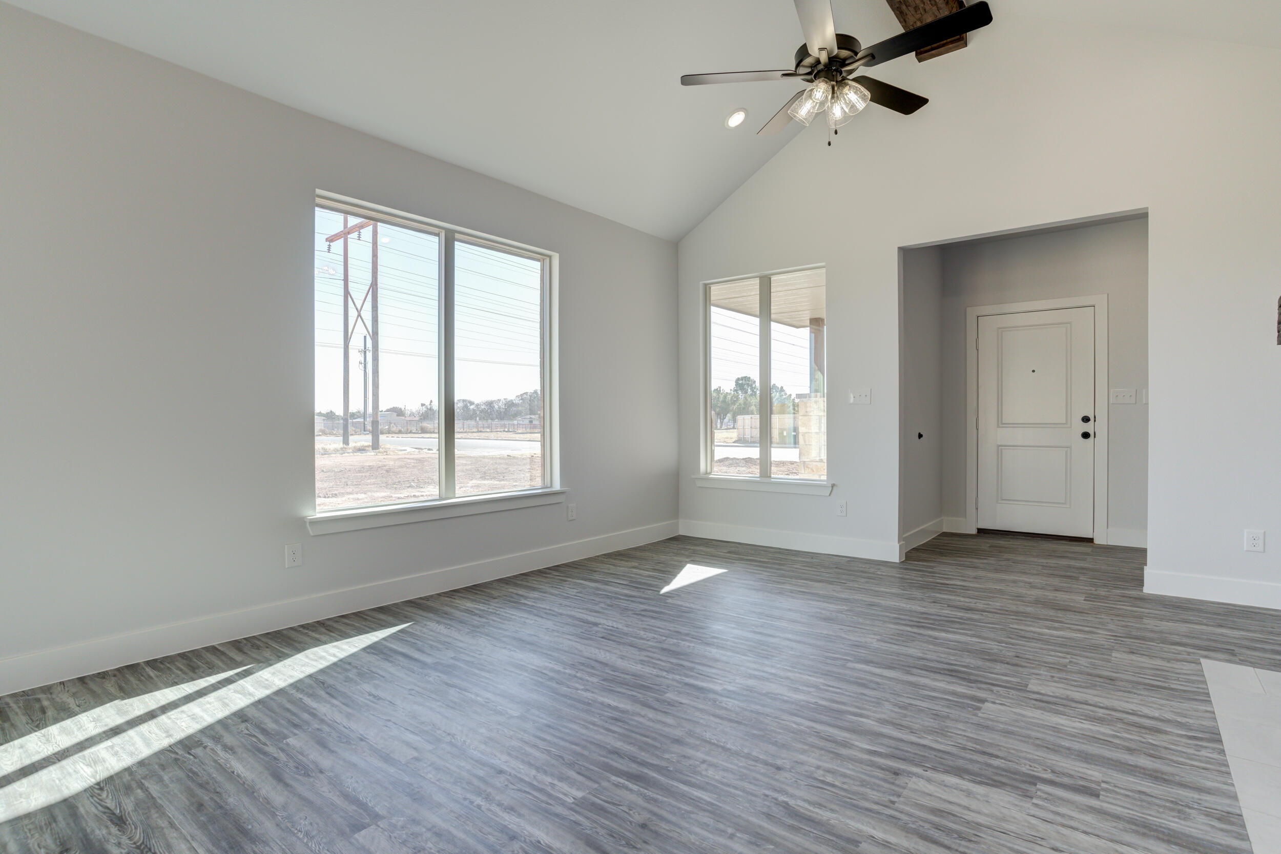 6926 12th Street Lubbock, TX 79416 - Photo 11 of 39 a view of an empty room with a window and wooden floor