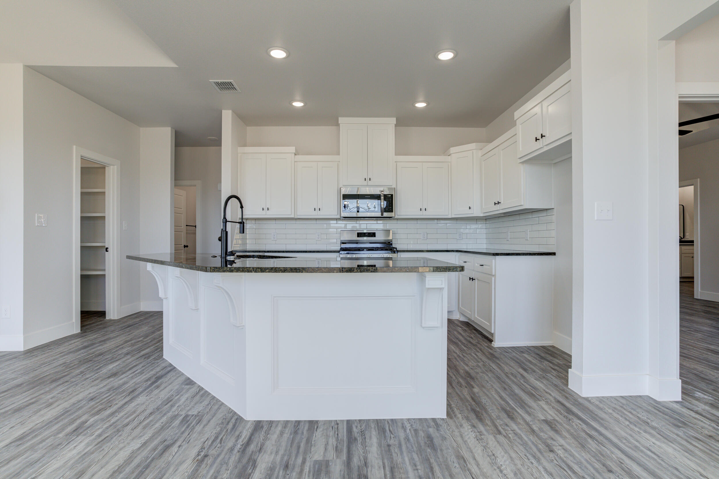 6926 12th Street Lubbock, TX 79416 - Photo 15 of 39 a kitchen with kitchen island stainless steel appliances a sink and refrigerator