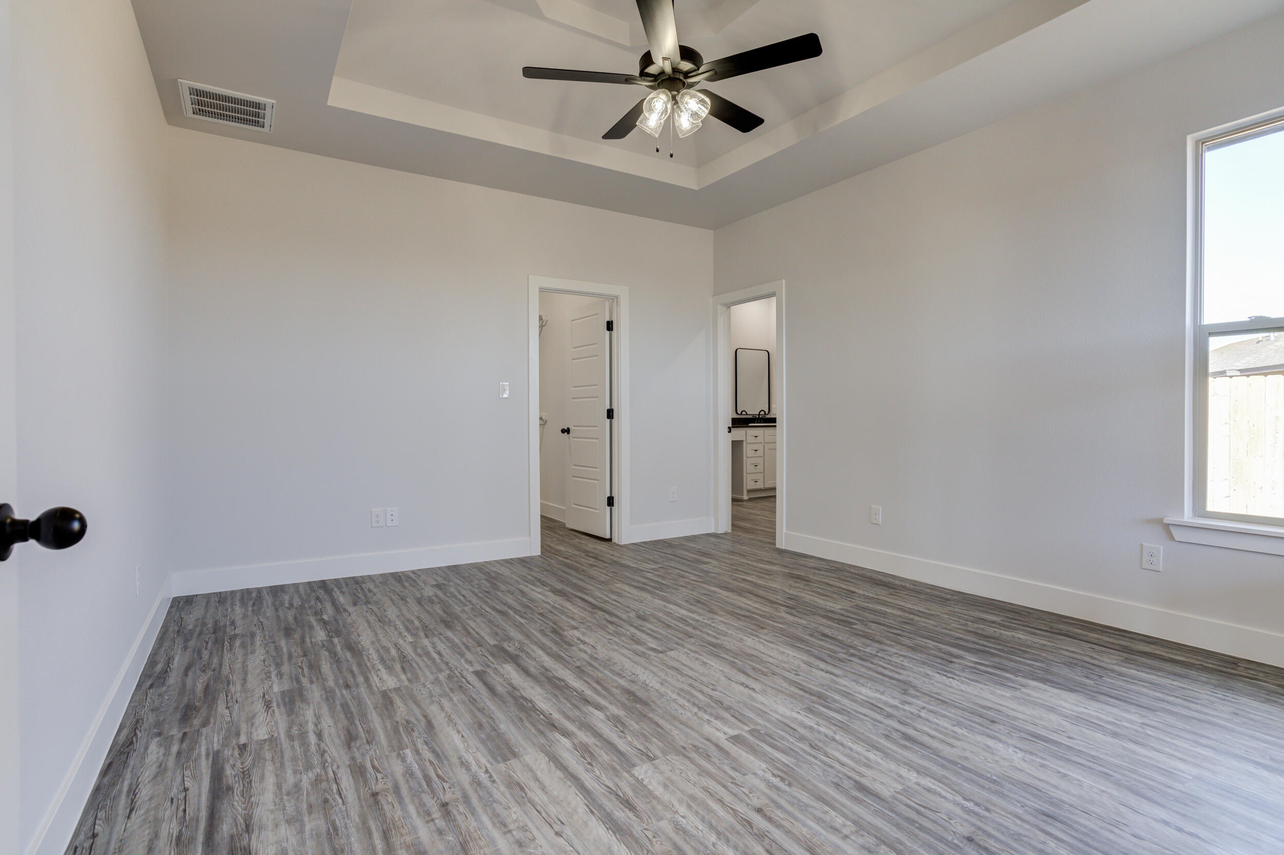 6926 12th Street Lubbock, TX 79416 - Photo 21 of 39 wooden floor in an empty room with a window