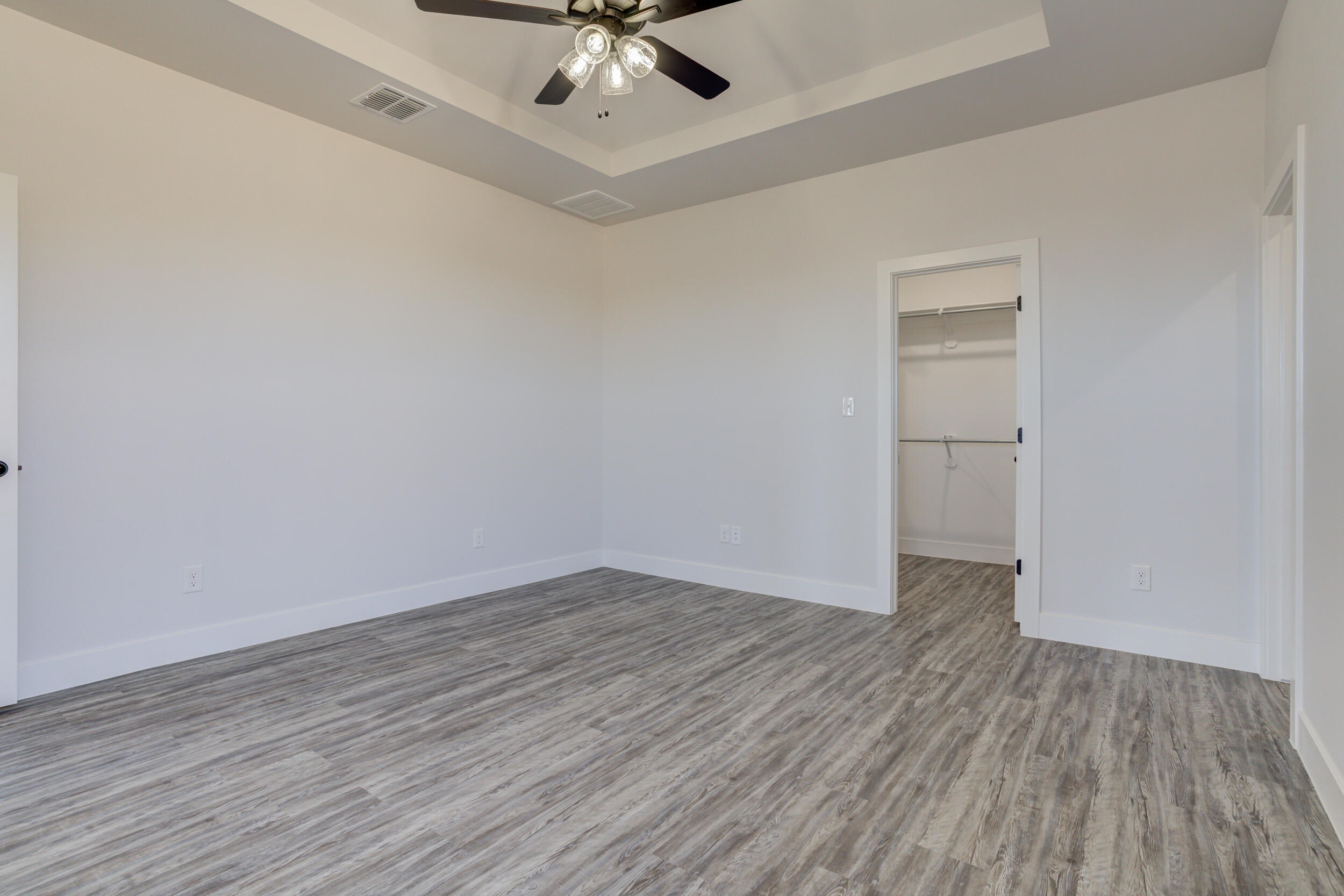 6926 12th Street Lubbock, TX 79416 - Photo 22 of 39 a view of an empty room with wooden floor
