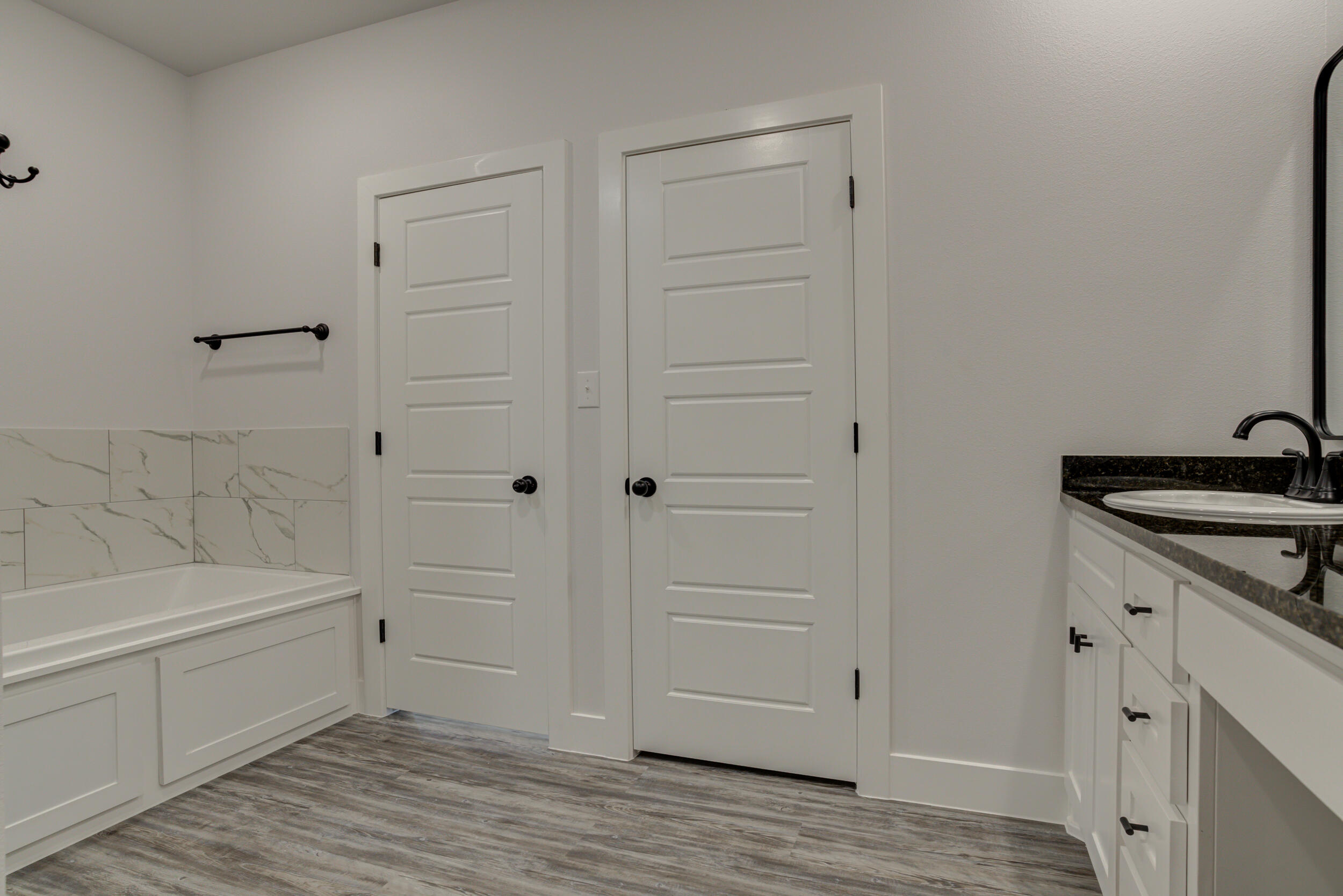 6926 12th Street Lubbock, TX 79416 - Photo 28 of 39 a bathroom with a sink and a bathtub